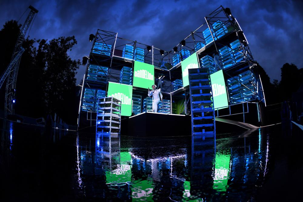 Images showing the main stage lit up at night at the Dandelion Festival